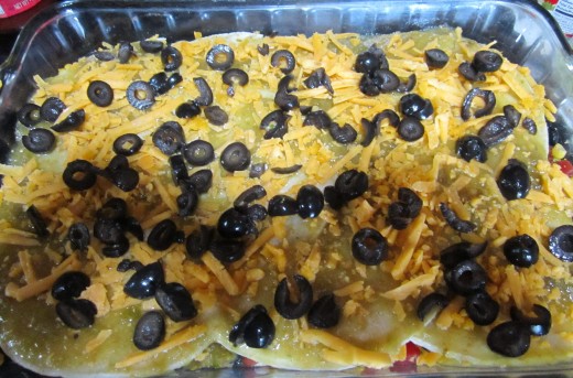 Top with more cheese and black olives, and casserole is ready for the oven!