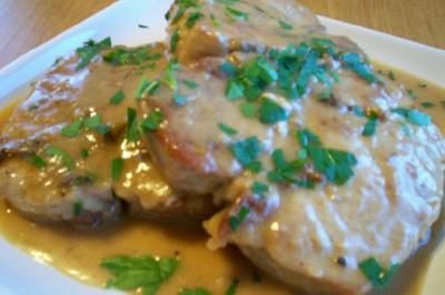 Smothered Pork Chops Are So Delicious. In this photo they are sprinkled with fresh dried crumbled parsley. 
