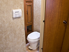 A typical trailer toilet is made of plastic.  Don't break it by stepping on it!
