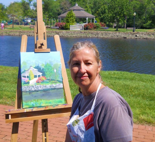 Deborah McClure poses with her painting.