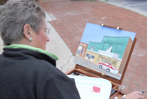 Arlene Matzkin painting the Milton Theatre, capturing a piece of Milton's history for posterity. 