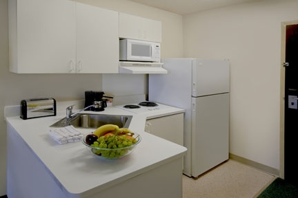 Full size fridge, electric range, and microwave. Only Deluxe locations have a dishwasher and stove.