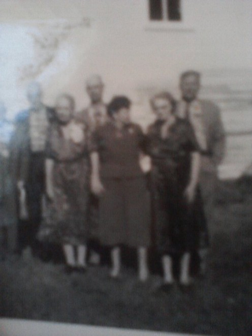 My grandmother with family in Elma, Iowa many years ago. The photo is very old.