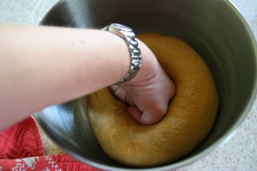 Punch down the risen dough ball.