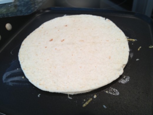 Cook quesadilla until cheese melts and both sides are crispy