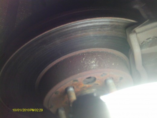 Grooves in a rotor are indicators of damage; a rotor needs to be resurfaced or replaced if it looks like an old LP record.