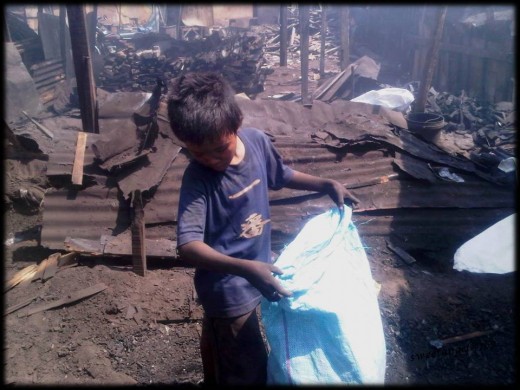 mark, 11 year old boy working at the charcoal factory to help his family :(