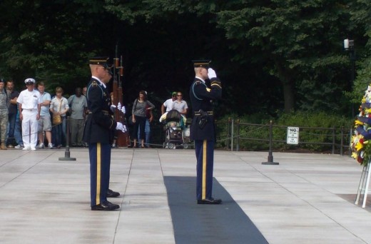 The soldier rose to his feet to salute with the Guard