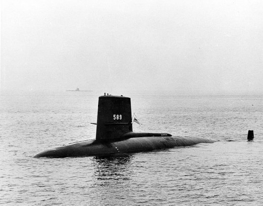 USS Scorpion (SSN-589) 22 August 1960, off New London, Connecticut. A "GUPPY" type submarine is faintly visible in the distance, just beyond the forward tip of Scorpion's "sail".