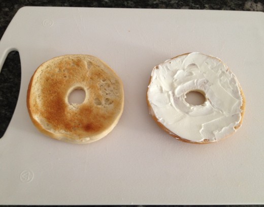 Toast bagels and cool about 30 seconds before spreading with cream cheese.