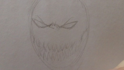 sketch in draft teeth lines and cheek bones.