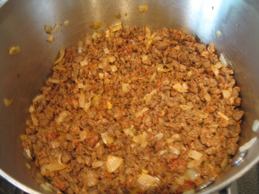 Make sure you add the tomato puree to the sauteed onion and garlic. It will give a nice reddish color. The mince Quorn or soya meat will be added before the tomato sauce to toast it a bit.