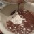 Adding the cooked mixture to the dry ingredients for the cake. 