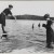 Title: [Woman standing a lake, photographing another woman who is perched to dive] Date: 1900 Comments: Those were the swimwear back in the day . 