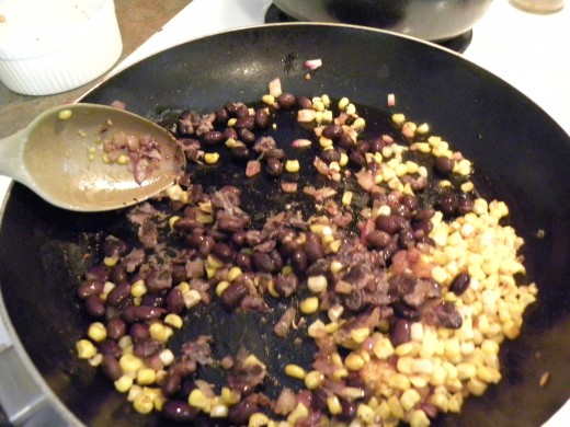 The cooked corn, beans, garlic and onion used in the quesadillas