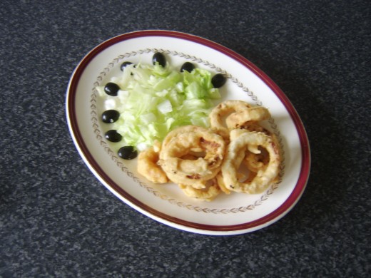 Lettuce and onion rings are plated
