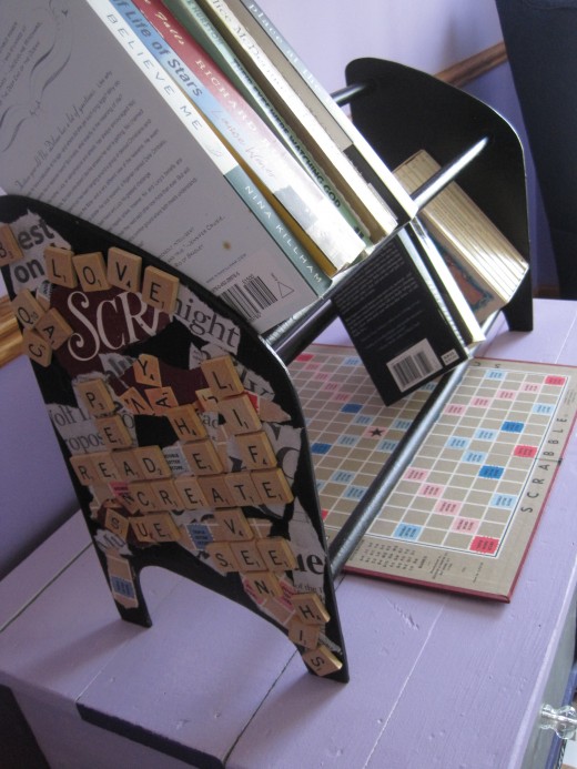 Book rack with scrabble board underneath.