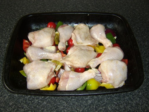 Chicken portions are laid on vegetables