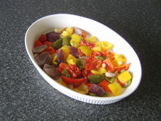 Vegetables are laid in the base of a serving dish