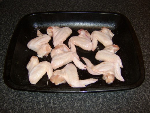 Wings are laid on a roasting tray