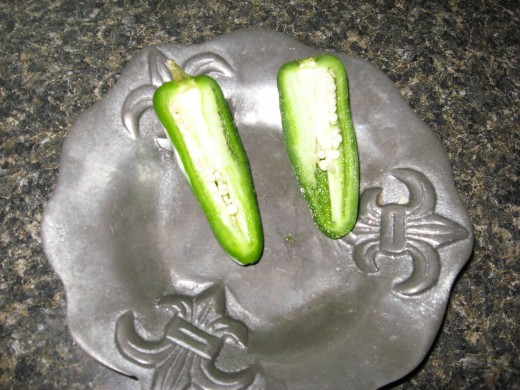 Cut jalapenos in half and remove seeds and ribs.