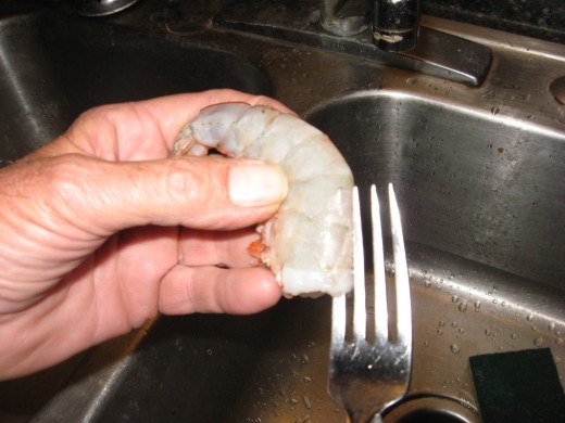 Insert a tine just under the peel.