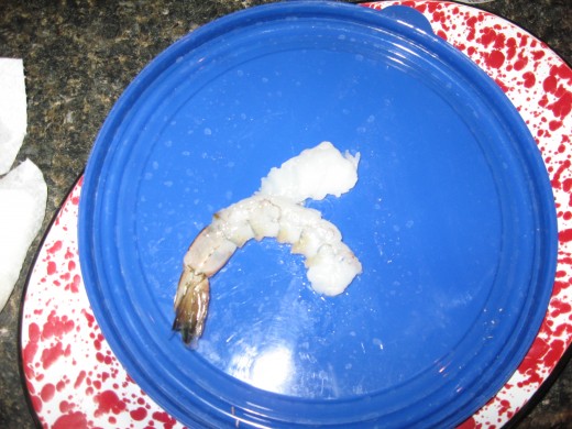 To butterfly shrimp, slice through a peeled, deveined shrimp to within one inch of the tail.