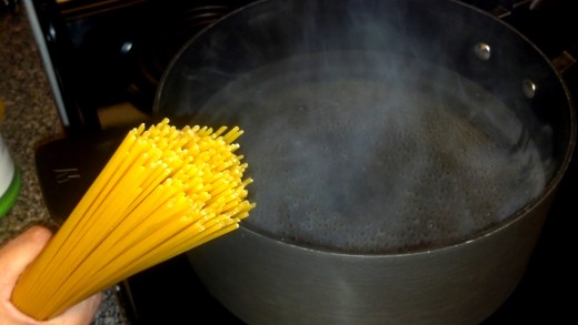Boil the water and cook 10 oz of spaghetti noodles.