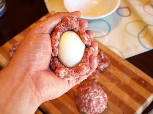 Wrap your eggs in the sausage meat.