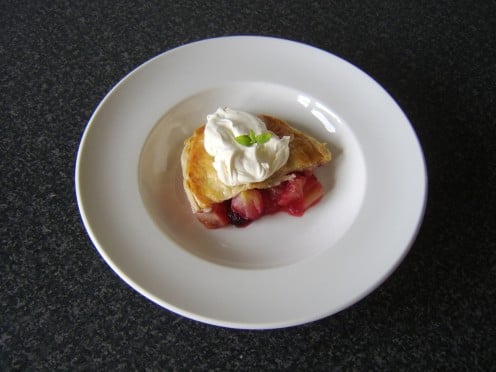 A sprig of mint makes an attractive garnish for this chilled apple, blackberry and cinnamon pie with whipped cream
