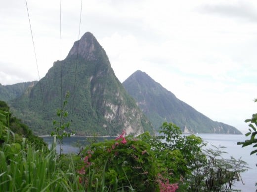 Gros Piton and Petit Piton are volcanic peaks that landmark the island.  Over the Choiseul Tuff behind them that forms part of the lip of the caldera is the crater of the still-active volcano.