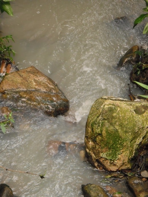 Fed by constant run-off during the rainy season, streams flow quickly near the drive-in volcano  at Soufriere, Saint Lucia.