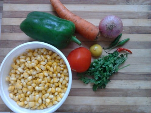 Boiled sweet corn, carrot, green bell pepper, lemon, onion, green chillies, some coriander leaves