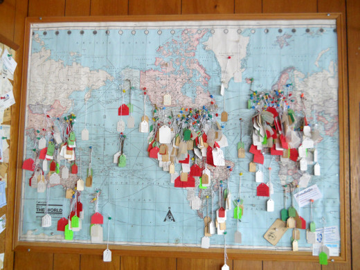 One of 4 large wall maps that shows parts of the world that visiting tourists have come from.