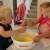 Together the kids get silly while mixing the eggs!