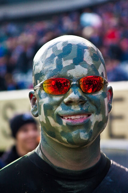 True sports fanastics paint their faces before attending a sporting event.