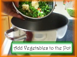 Adding Albondigas Vegetables to the Pot: Put tomatoes, onions and garlic into a soup pot.