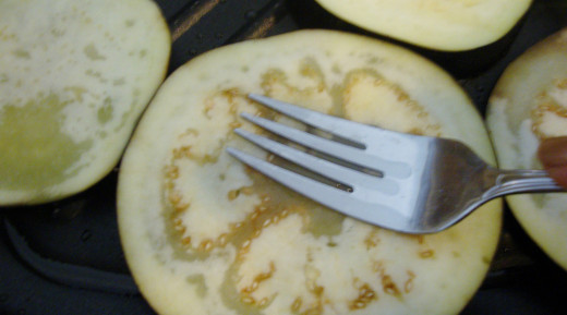 Pressing down on each slice causes the juices to be released and the eggplant will begin to steam and sizzle.