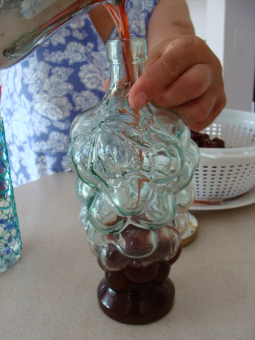 Pour the cherry liqueur into a container for storage.