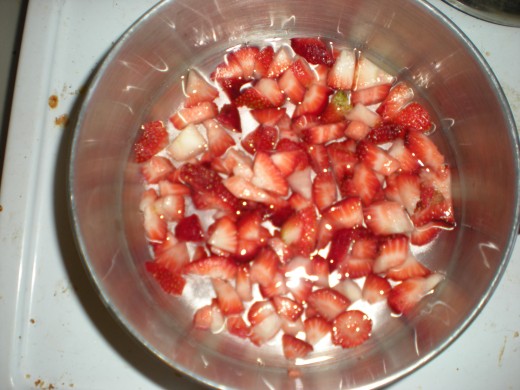 Chopped strawberries, sugar and water before cooking