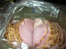 Place the ham into a baking bag in a casserole dish.