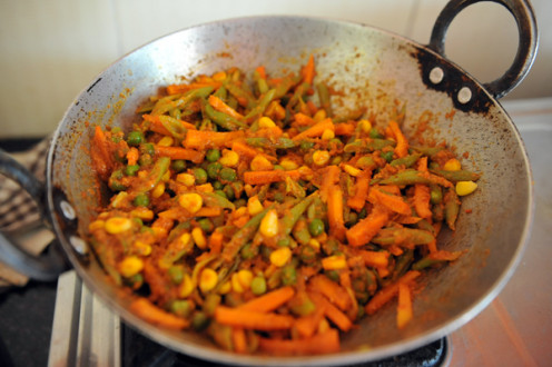 The third and final part of the cooked rice is to be mixed with the cooked vegetables.