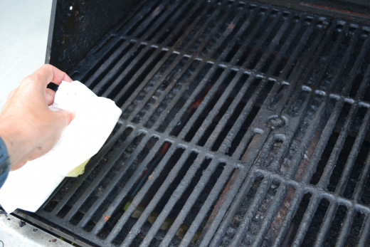 After cleaning grill grates, rub the grill with olive oil on a paper towel