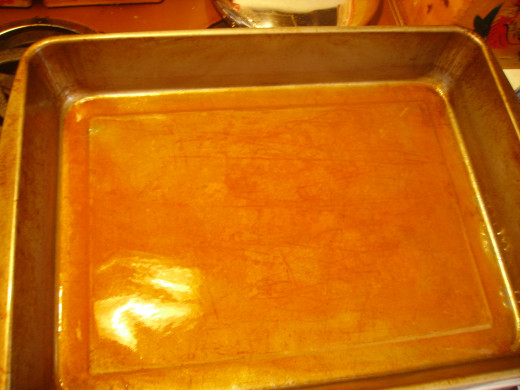 Bottom of pan, coated with cooking spray and enchilada sauce