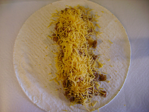 Layer first the ground beef/bean mixture, then the salsa, and finish with the shredded cheese.