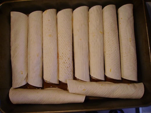 Place each stuffed tortilla in pan, with the end tucked underneath to prevent it unrolling.