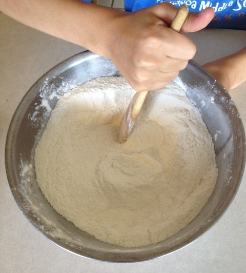 Stirring some of the applesauce cake ingredients together.
