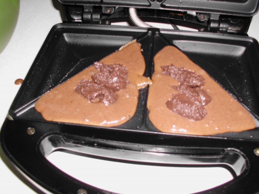 Pour the batter, add any filling in the center of each triangle.