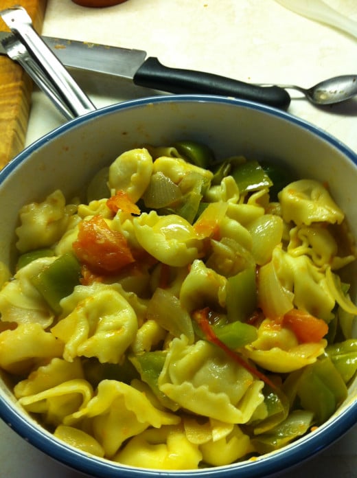 Toss tortellini together in a bowl with veggies.