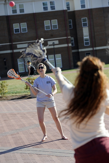 Tossing the ball lacrosse style by the fountain